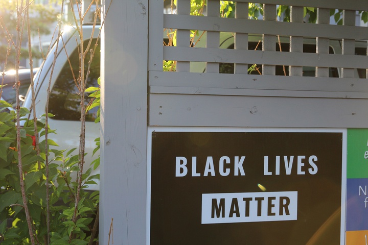 a black lives matter sign on a fence in Cambridge